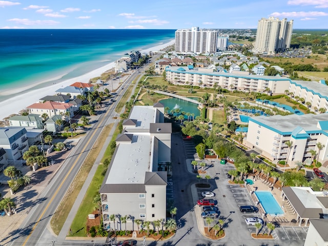 birds eye view of property with a beach view and a water view