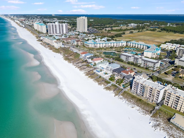 birds eye view of property with a view of city, a water view, and a beach view