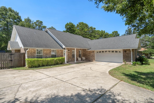 ranch-style house with a garage and a front yard