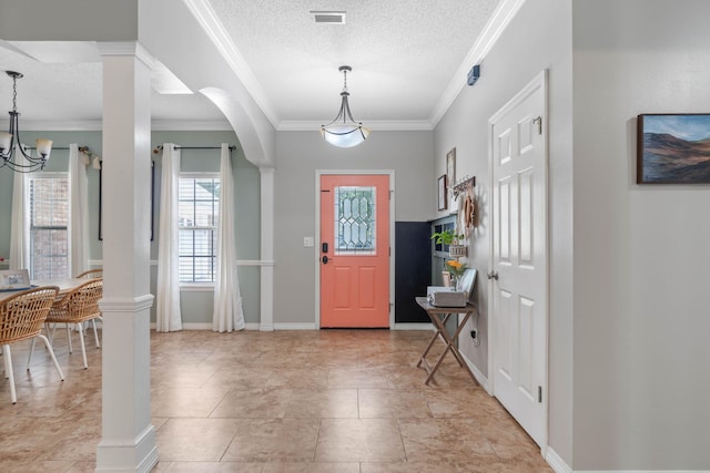 entryway with a textured ceiling, light tile patterned floors, and ornamental molding