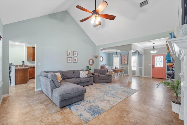 tiled living room featuring ceiling fan and high vaulted ceiling