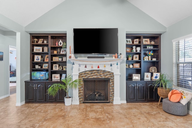 tiled living room with lofted ceiling and a stone fireplace