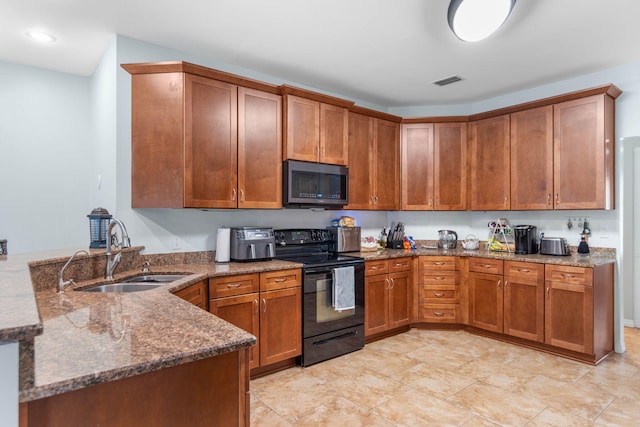 kitchen featuring sink, black appliances, light tile patterned floors, kitchen peninsula, and dark stone countertops