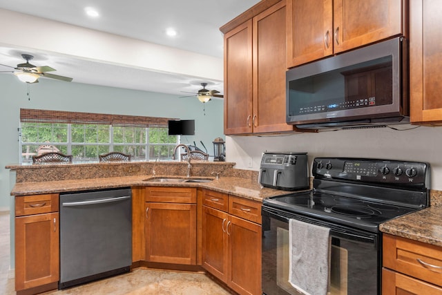 kitchen featuring ceiling fan, appliances with stainless steel finishes, sink, and stone countertops