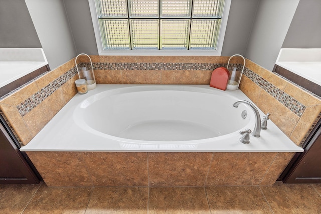 bathroom featuring tiled tub and tile patterned floors