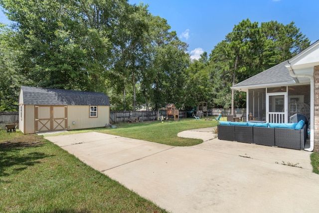 view of yard with a patio, a playground, outdoor lounge area, and a storage unit