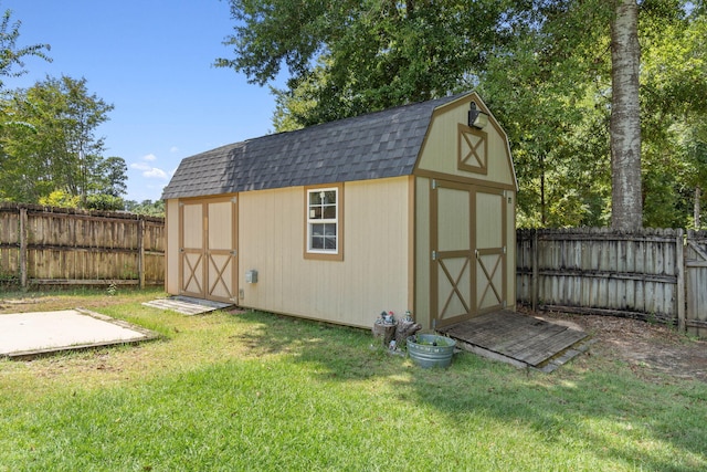 view of outbuilding with a lawn