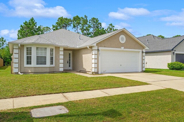 ranch-style home featuring a garage and a front yard