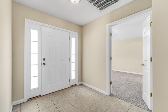 entryway with light tile patterned floors