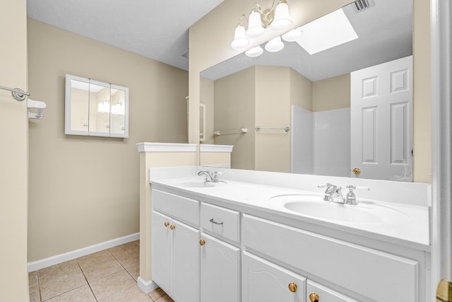 bathroom featuring vanity, walk in shower, tile patterned floors, and a skylight