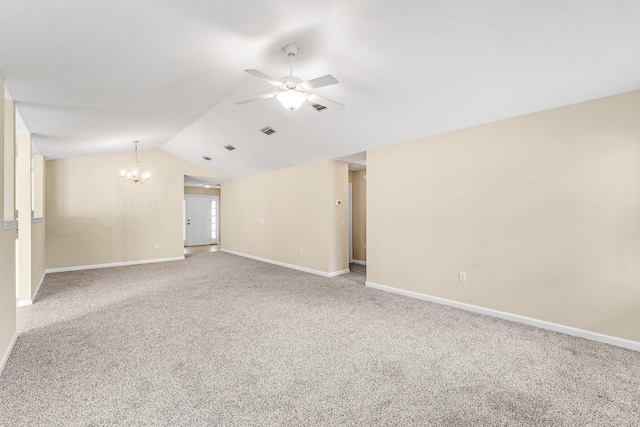 spare room with ceiling fan with notable chandelier, vaulted ceiling, and carpet