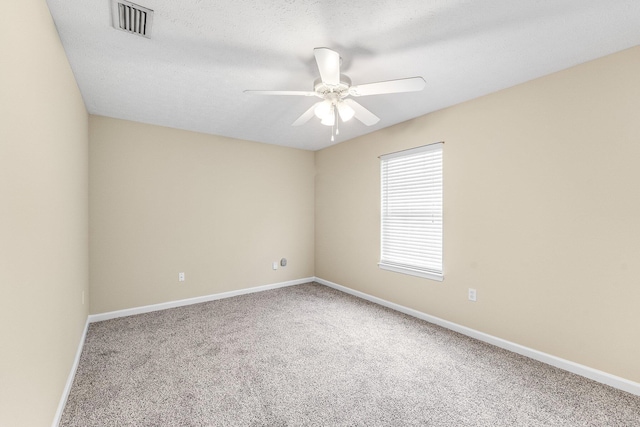 empty room with carpet flooring, a textured ceiling, and ceiling fan