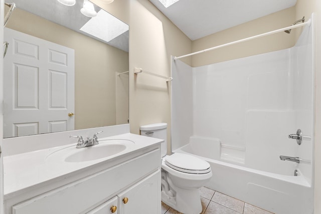 full bathroom with vanity, a skylight, tile patterned floors, and toilet