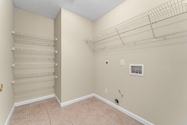 washroom with gas dryer hookup, tile patterned flooring, hookup for a washing machine, hookup for an electric dryer, and a textured ceiling