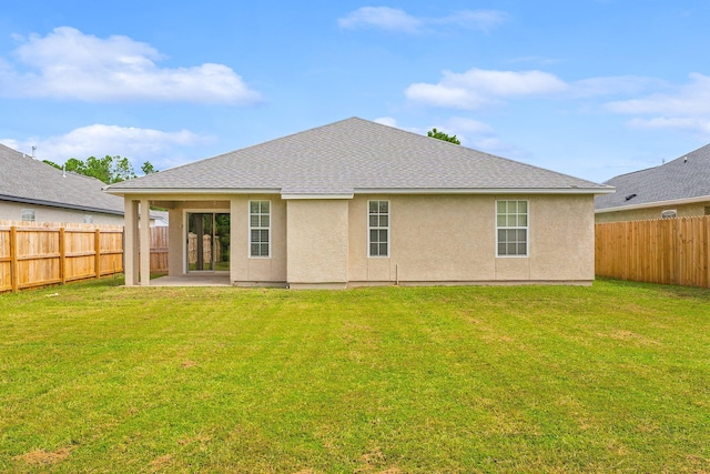 rear view of house with a patio area and a lawn