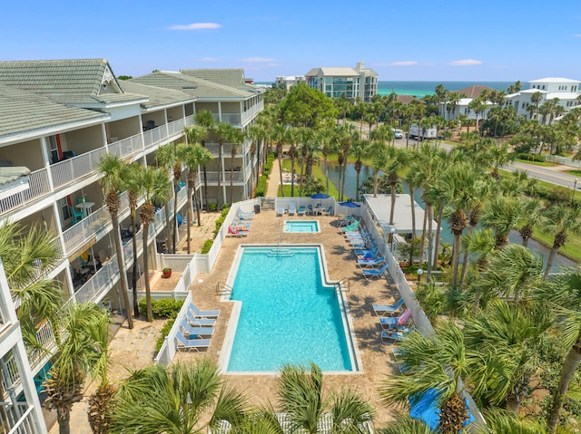 view of pool featuring a patio and a water view