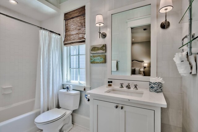 full bathroom with vanity, toilet, and shower / tub combo with curtain