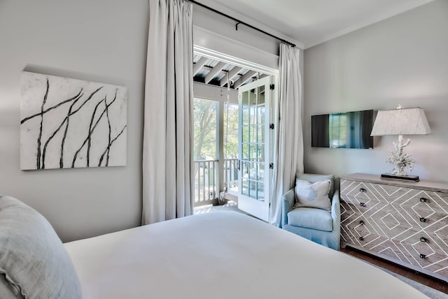 bedroom with dark wood-type flooring and access to exterior