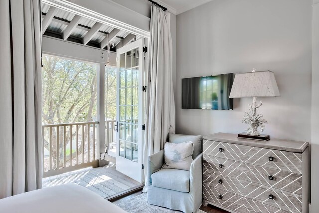 bedroom featuring access to exterior and hardwood / wood-style flooring