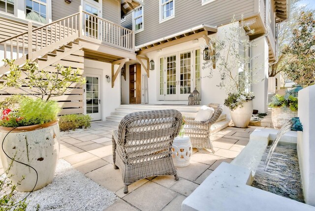 view of patio / terrace featuring a balcony and french doors