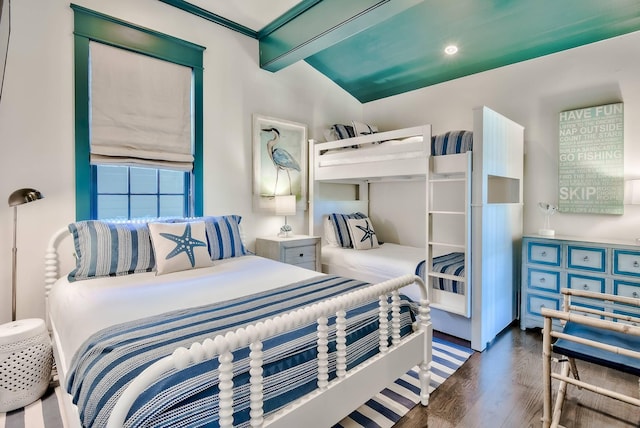 bedroom featuring vaulted ceiling with beams and dark hardwood / wood-style flooring