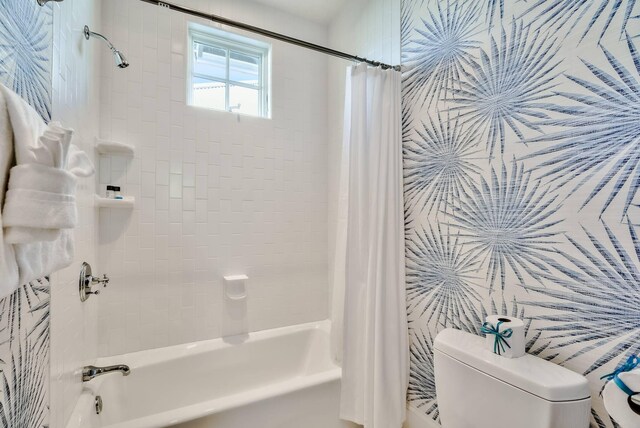 bathroom featuring toilet and shower / bathtub combination with curtain