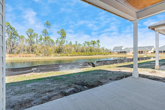 view of yard with a water view and a patio