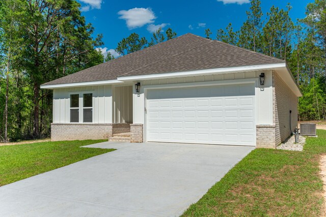 view of front of house featuring a garage and a front lawn