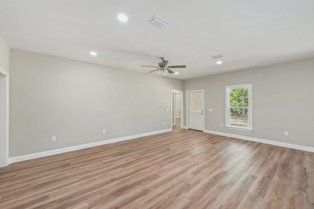 empty room with light hardwood / wood-style flooring and ceiling fan