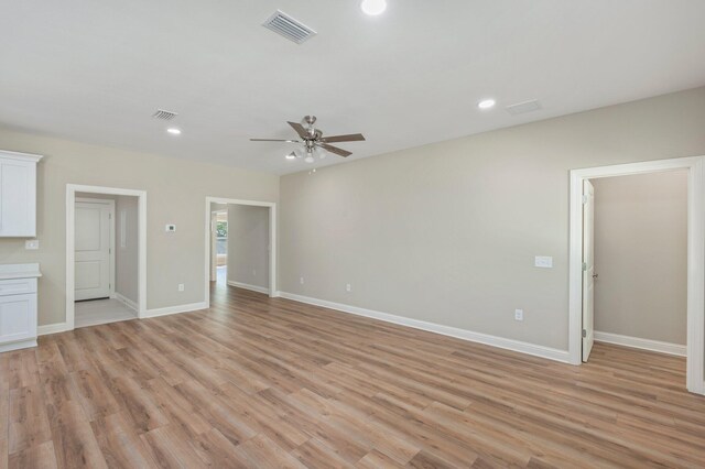 spare room featuring ceiling fan and light hardwood / wood-style flooring