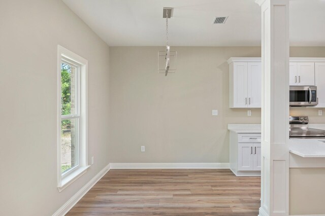 unfurnished dining area featuring light hardwood / wood-style flooring