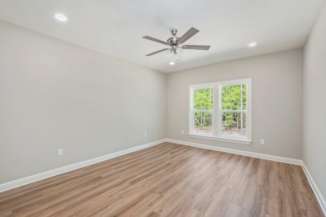 spare room with ceiling fan and light hardwood / wood-style flooring