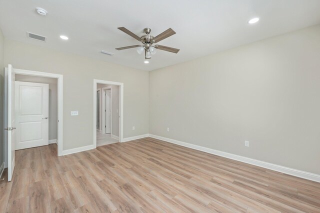 unfurnished bedroom with ceiling fan and light wood-type flooring