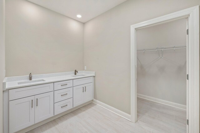 bathroom with tile patterned flooring and dual sinks