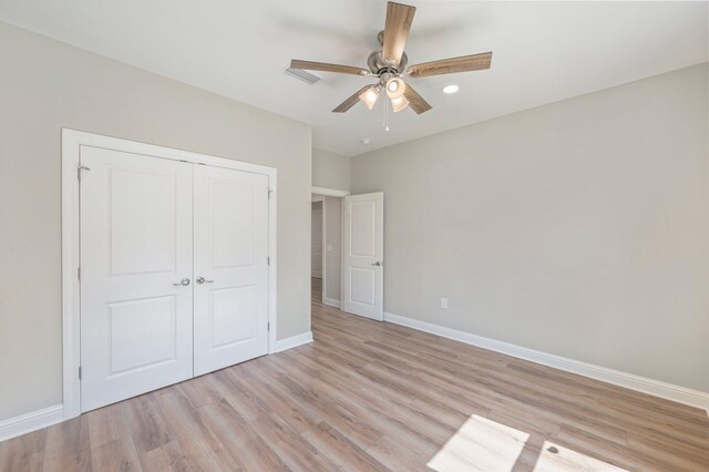 unfurnished bedroom with a closet, ceiling fan, and light wood-type flooring