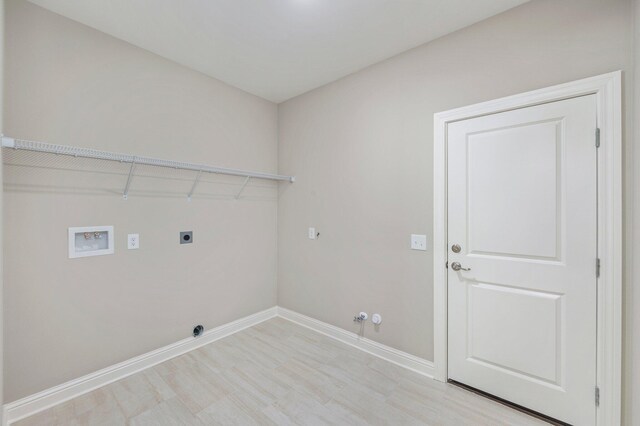 laundry room with hookup for an electric dryer, hookup for a washing machine, light hardwood / wood-style floors, and gas dryer hookup