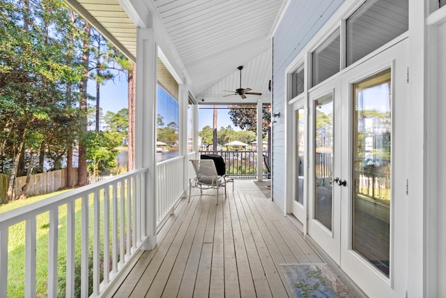 wooden terrace with covered porch, fence, and a ceiling fan