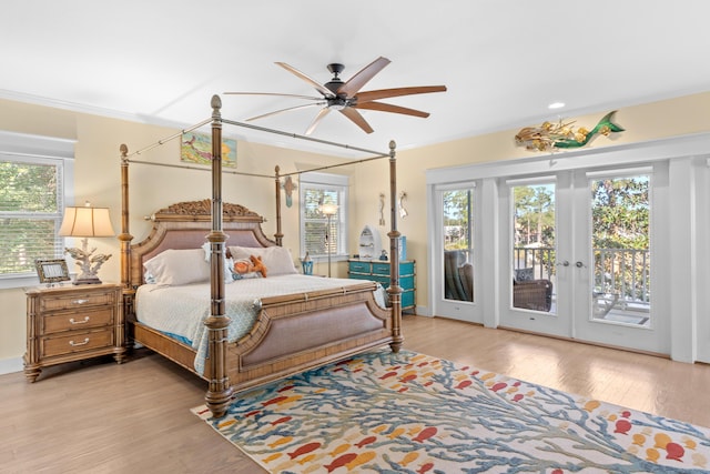 bedroom featuring access to outside, french doors, multiple windows, and light wood-style flooring