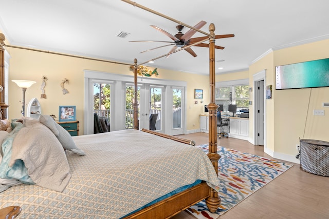 bedroom featuring ceiling fan, access to outside, wood-type flooring, and multiple windows