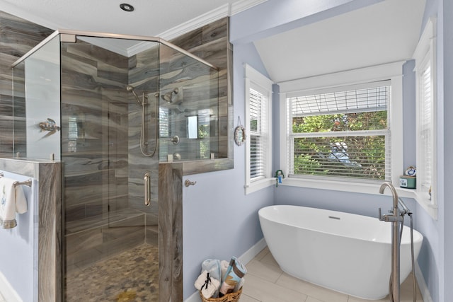 bathroom featuring tile patterned floors, vaulted ceiling, and shower with separate bathtub