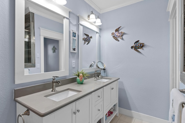 full bathroom with crown molding, a sink, baseboards, and double vanity