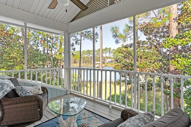 sunroom with ceiling fan and lofted ceiling