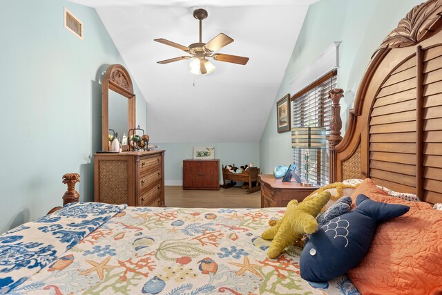 bedroom featuring ceiling fan, lofted ceiling, and light wood-type flooring