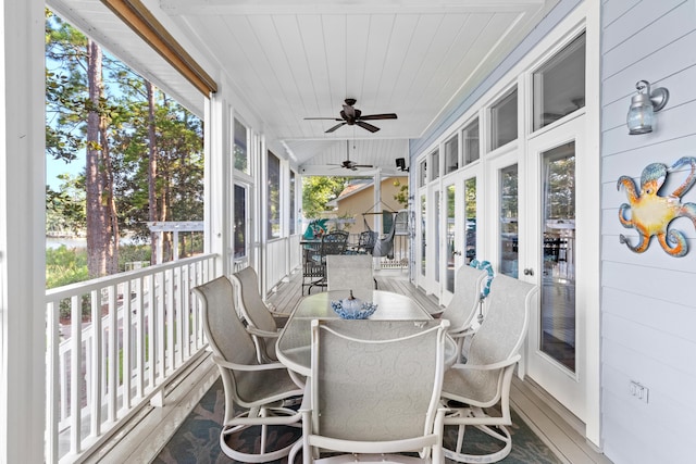 sunroom with ceiling fan and wood ceiling