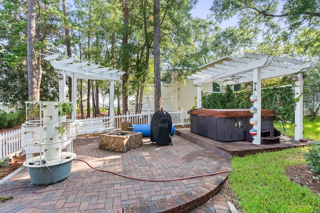 view of patio with fence, a hot tub, and a pergola