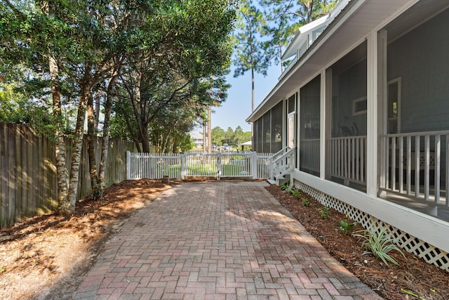 view of patio with a sunroom and a fenced backyard