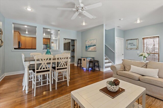 living room featuring hardwood / wood-style flooring and ceiling fan