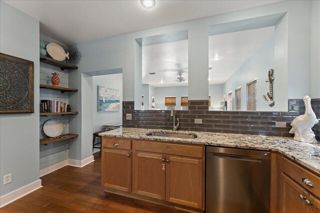 kitchen with sink, dark hardwood / wood-style flooring, stainless steel dishwasher, tasteful backsplash, and ceiling fan