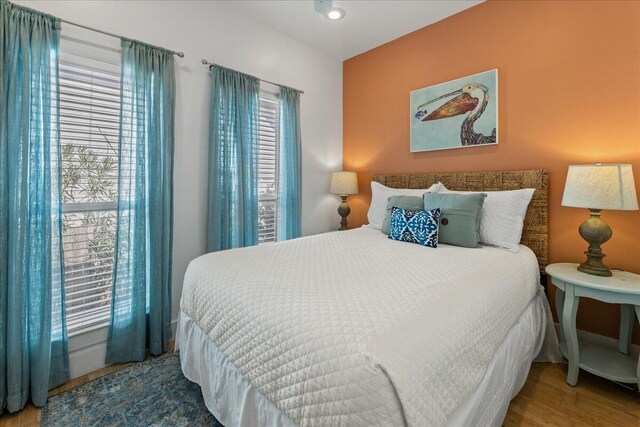 bedroom featuring multiple windows and wood-type flooring