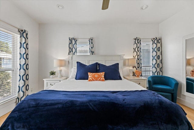 bedroom with ceiling fan and light hardwood / wood-style flooring